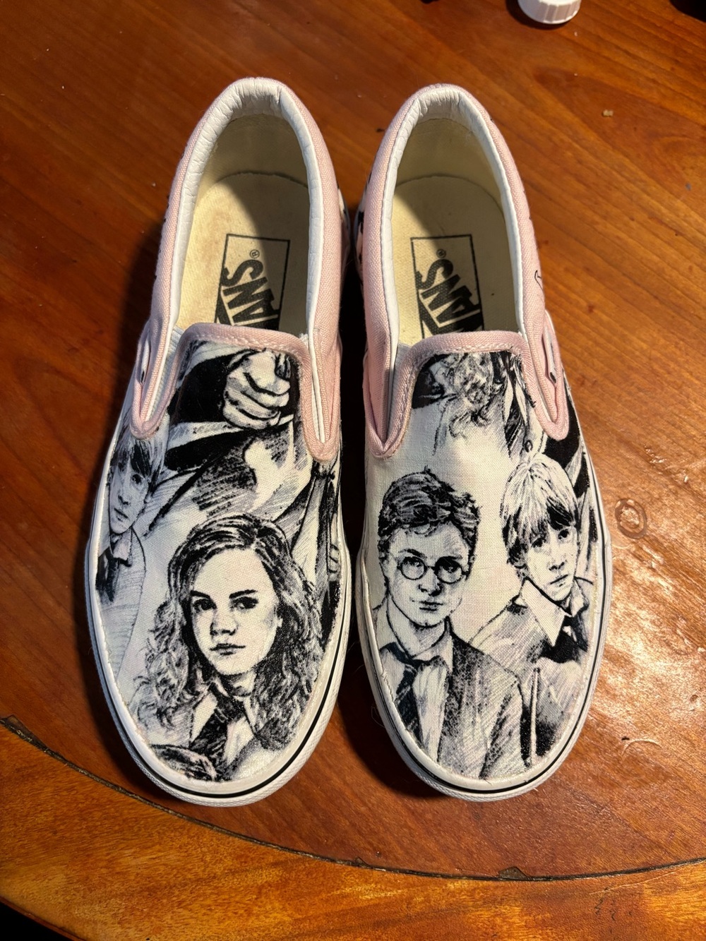 Vans Slip-On Sneakers with Black Character Sketches and Pink Trim